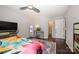 Spacious bedroom with dark wood floors, ceiling fan, and access to the bathroom and closet at 9239 N Vicksburg Park Ct, Charlotte, NC 28210