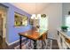 Dining room features a wooden table, modern chandelier, and a glimpse into the kitchen at 9239 N Vicksburg Park Ct, Charlotte, NC 28210