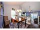 Well-lit dining room with a wooden table, chandelier, and view into the cozy living room at 9239 N Vicksburg Park Ct, Charlotte, NC 28210