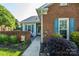 Charming home featuring a brick exterior, inviting walkway, and well-manicured landscaping at 9239 N Vicksburg Park Ct, Charlotte, NC 28210
