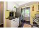 Kitchen featuring stainless steel appliances, white cabinets, and access to the laundry room at 9239 N Vicksburg Park Ct, Charlotte, NC 28210