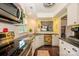Bright kitchen with white cabinets, stainless steel appliances, and a view into the dining area at 9239 N Vicksburg Park Ct, Charlotte, NC 28210