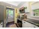 Kitchen with stainless steel appliances, granite countertops, and a view to the laundry room at 9239 N Vicksburg Park Ct, Charlotte, NC 28210