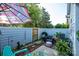 Fenced in backyard patio with outdoor seating, a grill, and a colorful umbrella at 9239 N Vicksburg Park Ct, Charlotte, NC 28210