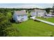Aerial view of the property showing a lush lawn, well-kept landscaping, and a fenced pool area at 104 Rockridge Point Dr, Mooresville, NC 28117