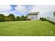 Spacious backyard showcasing a well-maintained lawn and the rear exterior of the two-story home at 104 Rockridge Point Dr, Mooresville, NC 28117