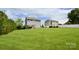 Large backyard features a lush lawn, the home's rear exterior, and neighboring properties at 104 Rockridge Point Dr, Mooresville, NC 28117