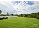 Expansive backyard featuring a lush green lawn and a privacy fence, perfect for outdoor activities at 104 Rockridge Point Dr, Mooresville, NC 28117