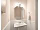 Charming powder room featuring beadboard paneling and a pedestal sink with an octagon mirror at 104 Rockridge Point Dr, Mooresville, NC 28117