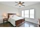 Inviting bedroom with a ceiling fan, wood flooring, and a large window for natural light at 104 Rockridge Point Dr, Mooresville, NC 28117