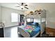 Cozy bedroom with bunk beds, a colorful bedspread, and a ceiling fan at 104 Rockridge Point Dr, Mooresville, NC 28117