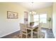 Bright dining area features hardwood floors, a chandelier, and a view of the kitchen at 104 Rockridge Point Dr, Mooresville, NC 28117