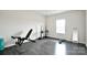 Functional exercise room with a weight bench, ample space, and natural light from the window at 104 Rockridge Point Dr, Mooresville, NC 28117