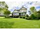 Charming two-story home boasts lush landscaping and a welcoming front porch with rocking chairs at 104 Rockridge Point Dr, Mooresville, NC 28117