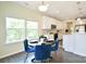 Bright eat-in kitchen features stainless appliances, marble backsplash, and a breakfast nook with natural light at 104 Rockridge Point Dr, Mooresville, NC 28117
