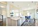 Bright, open-concept kitchen with marble countertops, bar seating, and views of the living room at 104 Rockridge Point Dr, Mooresville, NC 28117