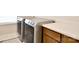 Well-lit laundry room with modern washer and dryer, and a convenient folding counter at 104 Rockridge Point Dr, Mooresville, NC 28117