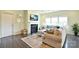 Cozy living room features a fireplace, large windows, and a comfortable sofa with stylish decor at 104 Rockridge Point Dr, Mooresville, NC 28117
