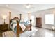 Beautiful main bedroom with four-poster bed, wood floors, and plenty of natural light at 104 Rockridge Point Dr, Mooresville, NC 28117