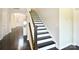Elegant staircase featuring dark wood treads and white risers, adding a touch of sophistication at 104 Rockridge Point Dr, Mooresville, NC 28117