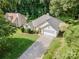 Overhead view of a single-story house featuring lush greenery, well-maintained lawns, and a driveway leading to a garage at 105 Banksridge Rd, Fort Mill, SC 29715