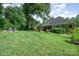 Spacious backyard with lush lawn, patio, and mature trees creating a private oasis at 105 Banksridge Rd, Fort Mill, SC 29715