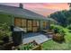 Backyard patio with outdoor seating, grill, and landscaped flower boxes at sunset at 105 Banksridge Rd, Fort Mill, SC 29715