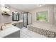 Stylish bathroom with double vanity, walk-in shower, soaking tub, and modern fixtures at 105 Banksridge Rd, Fort Mill, SC 29715