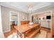 Dining room featuring a tray ceiling, an ornate chandelier and an adjoining living space at 105 Banksridge Rd, Fort Mill, SC 29715