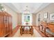 Dining room featuring a tray ceiling, an ornate chandelier and an adjoining living space at 105 Banksridge Rd, Fort Mill, SC 29715