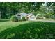 Single-story home with well-manicured front lawn, lush landscaping, and a two-car garage, exuding curb appeal at 105 Banksridge Rd, Fort Mill, SC 29715