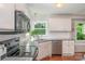 Well-lit kitchen with stainless steel appliances, granite countertops, and white cabinetry at 105 Banksridge Rd, Fort Mill, SC 29715