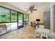Bright sunroom with tile flooring, ceiling fan, and access to outdoor patio at 105 Banksridge Rd, Fort Mill, SC 29715