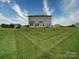 Expansive backyard with lush green grass and a view of the home's exterior at 114 Sierra Chase Dr, Statesville, NC 28677