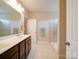 Bright bathroom features a double sink vanity, large mirror, and glass-enclosed shower stall at 114 Sierra Chase Dr, Statesville, NC 28677