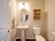 Elegant powder room with a pedestal sink, decorative shelving, and neutral tones at 114 Sierra Chase Dr, Statesville, NC 28677
