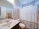 Bathroom featuring a sink, toilet, and a shower with a neutral-toned curtain at 114 Sierra Chase Dr, Statesville, NC 28677