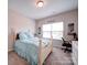 Bedroom featuring a white bed, dresser, and a window letting in plenty of natural light at 114 Sierra Chase Dr, Statesville, NC 28677