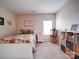 Cozy bedroom with white bed frame, warm colored bedding, and shelves with organized wicker baskets at 114 Sierra Chase Dr, Statesville, NC 28677