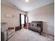 Bedroom with a crib, chair, storage bench and decorative wall art at 114 Sierra Chase Dr, Statesville, NC 28677