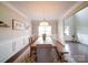 Dining area with seating for six at an elegant wooden table with bench, light fixture, and decorated walls at 114 Sierra Chase Dr, Statesville, NC 28677