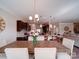 Dining room with a wooden table set for six people, with a view into the kitchen at 114 Sierra Chase Dr, Statesville, NC 28677