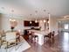 Open concept kitchen and dining area with seating for six around an elegant wooden table and chairs at 114 Sierra Chase Dr, Statesville, NC 28677