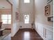 Bright foyer with hardwood floors, high ceilings, decorative wreath, and white wainscoting at 114 Sierra Chase Dr, Statesville, NC 28677