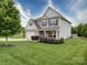 Charming home on a large lawn features tidy landscaping, a two-car garage, and inviting covered porch at 114 Sierra Chase Dr, Statesville, NC 28677