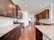 Spacious kitchen with granite countertops, stainless steel appliances, dark wood cabinetry, and a tile backsplash at 114 Sierra Chase Dr, Statesville, NC 28677