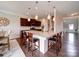 Modern kitchen with granite counters, dark wood cabinets, and island with bar stool seating and elegant pendant lighting at 114 Sierra Chase Dr, Statesville, NC 28677