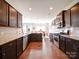 Well-lit kitchen featuring granite countertops, stainless steel appliances, dark wood cabinets, and eat in area at 114 Sierra Chase Dr, Statesville, NC 28677
