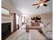 Open-concept living room with a fireplace, large sectional sofa, and hardwood floors at 114 Sierra Chase Dr, Statesville, NC 28677