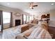 Bright living room with a fireplace and hardwood floors open to dining room and kitchen at 114 Sierra Chase Dr, Statesville, NC 28677